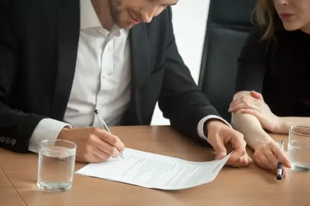 satisfied-smiling-businessman-suit-signing-contract-meeting-concept_1163-4653